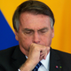 Jair Bolsonaro coughs during a press conference with Colombian President Ivan Duque at Planalto Palace on Oct. 19, 2021 in Brasilia.